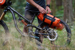 Assembling orange drybags on bike