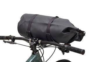 Black bicycle handlebar bag attached to a bike handlebar