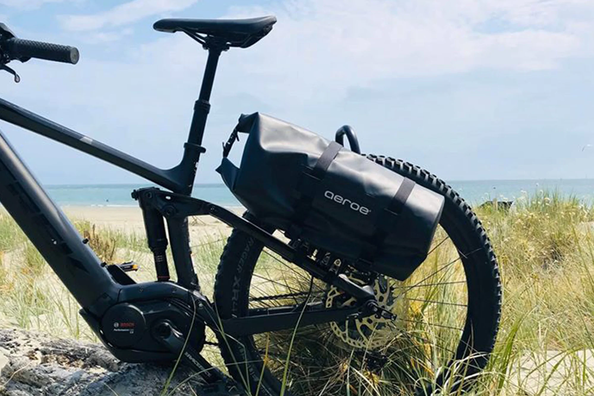 Black dry bag on bike at beach
