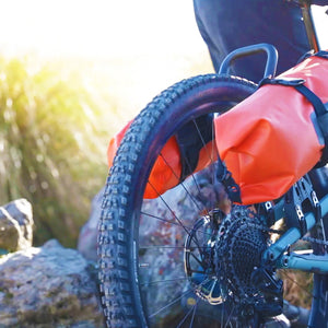 Orange dry bag on rear rack