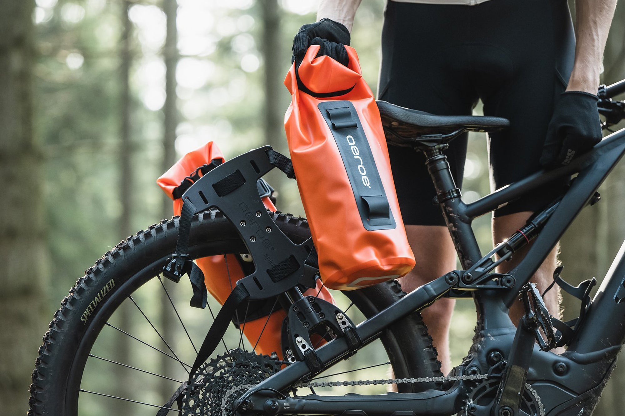 Two orange drybags on bike
